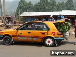 Cameroonian Taxi Drama: A Daily Urban Adventure A busy street scene in Cameroon with a yellow shared taxi navigating through traffic, reflecting daily urban life and the challenges of communal transport. Passengers are visible inside.