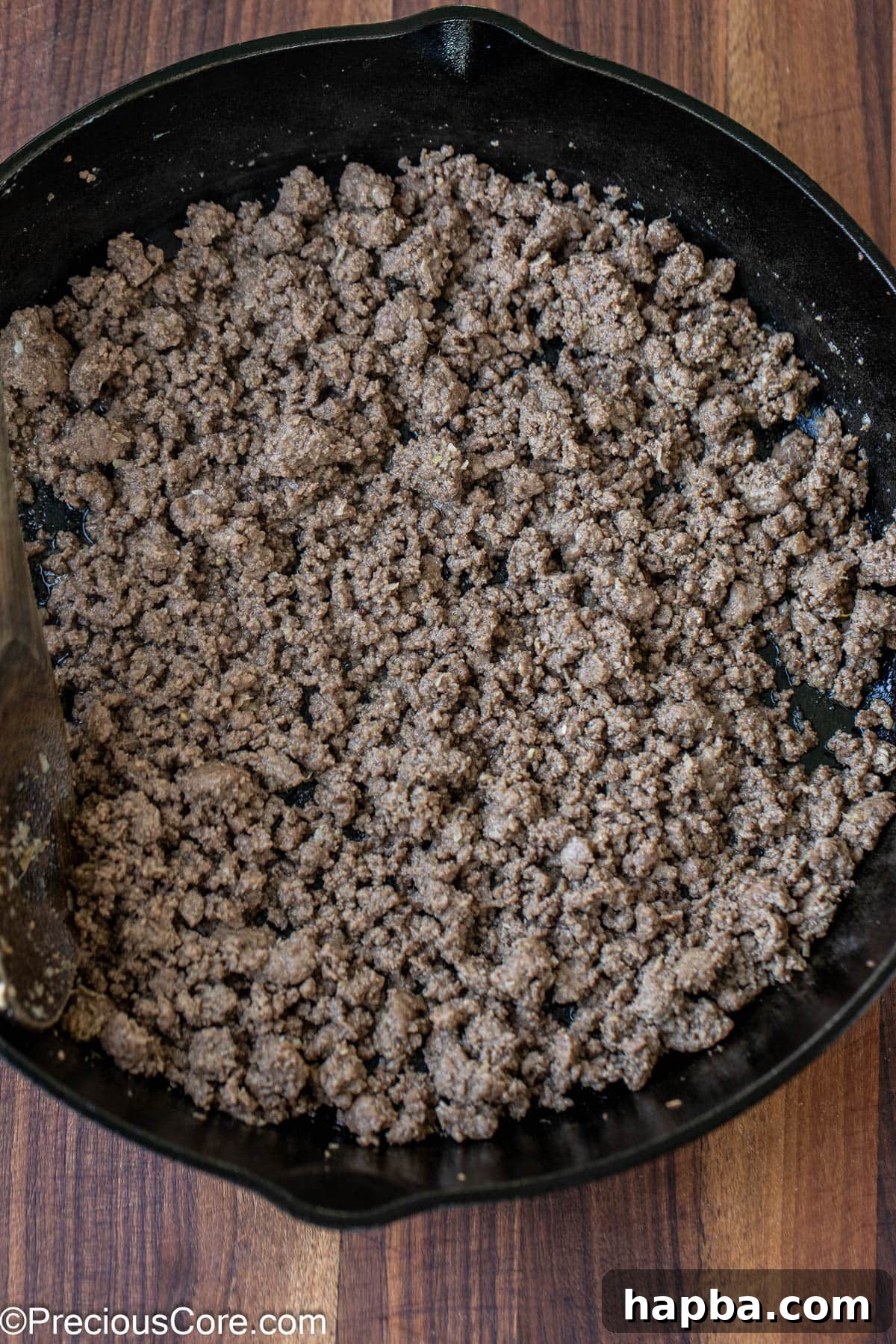 Cooked ground beef in a skillet.