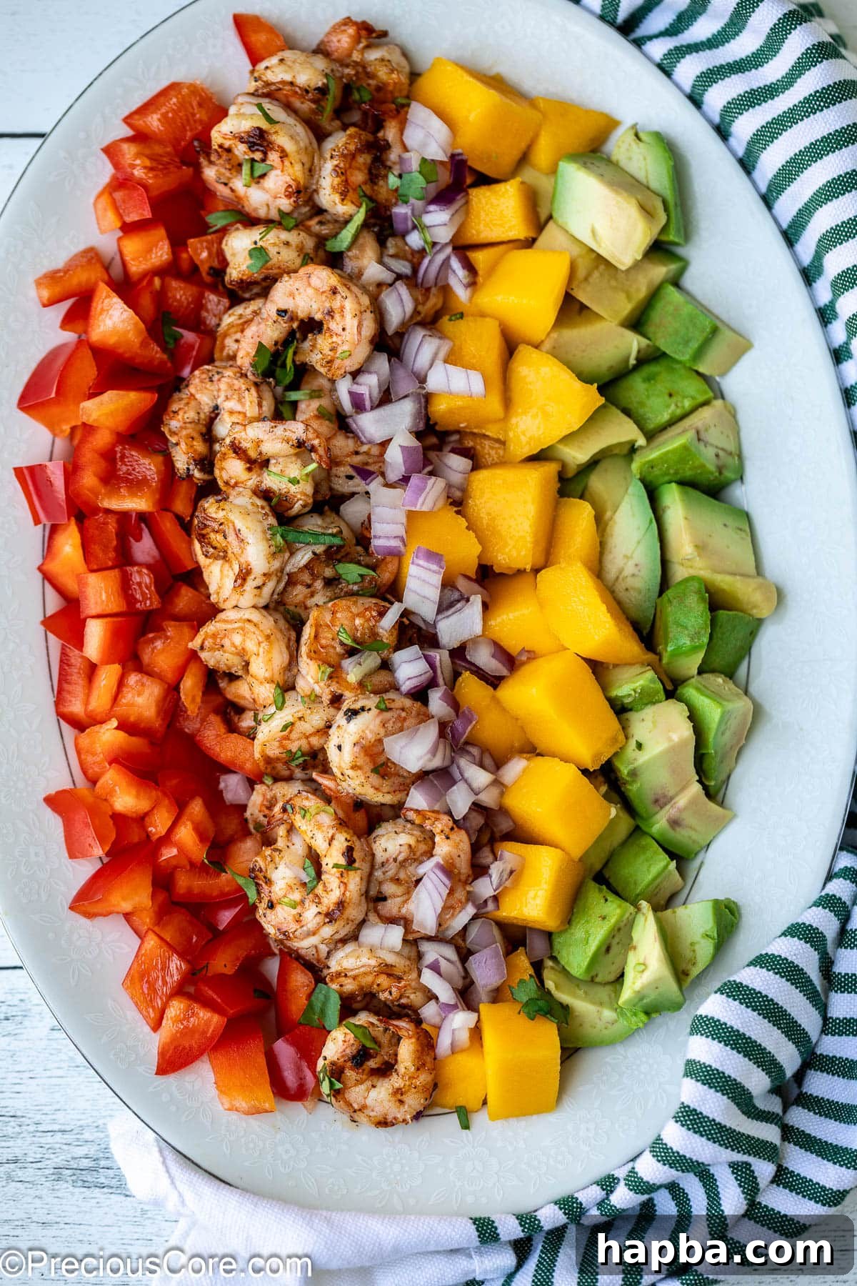Tropical Mango Shrimp Salad 2 A beautifully arranged Mango Shrimp Salad featuring diced mango, cooked shrimp, creamy avocado, and vibrant bell peppers, ready to be tossed.