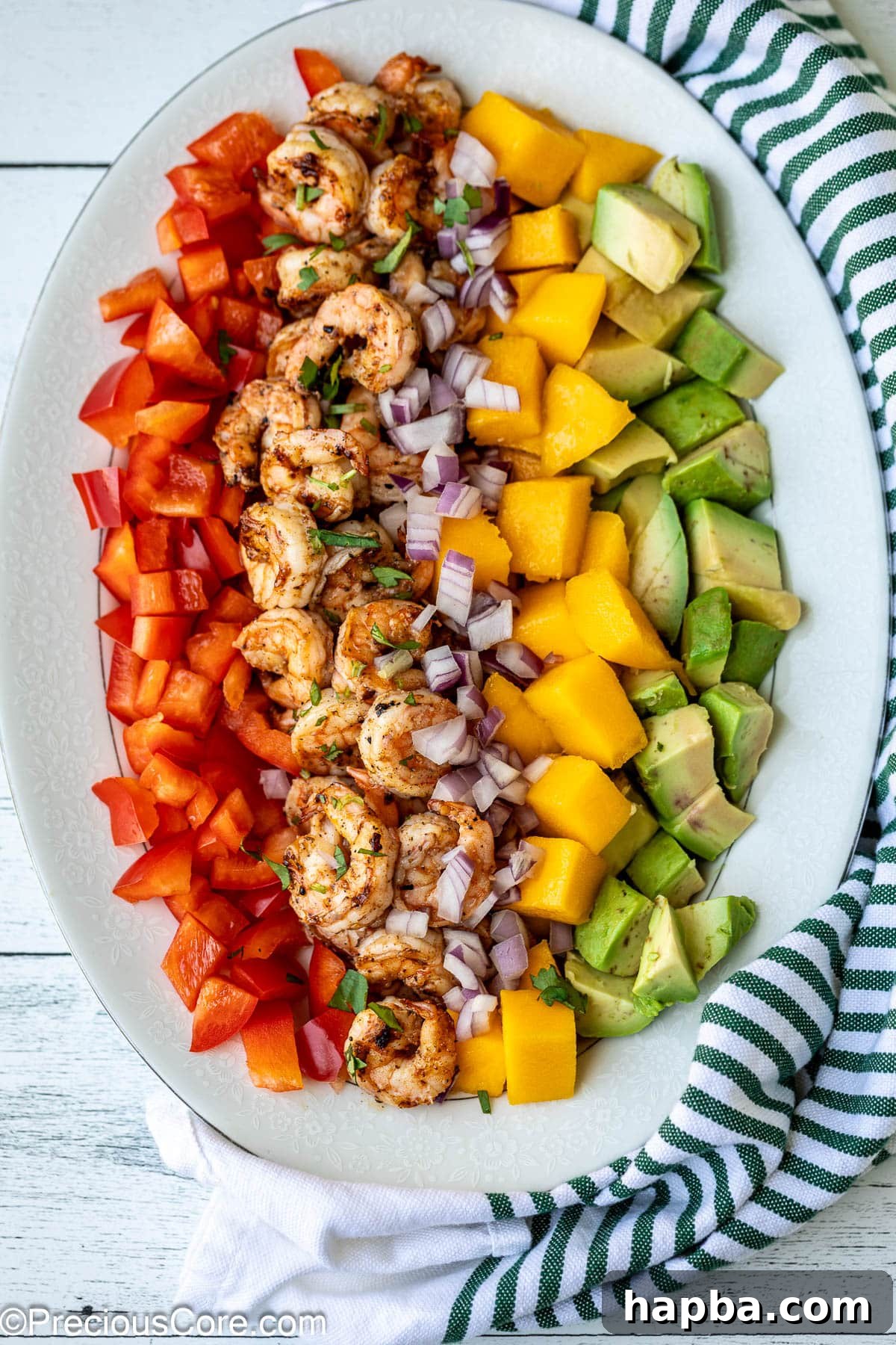 Tropical Mango Shrimp Salad 6 All the colorful ingredients for Mango Avocado Shrimp Salad artfully arranged on a platter before being tossed with dressing.