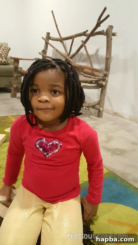 daughter with beautiful yarn braids, secured by her father Mr N