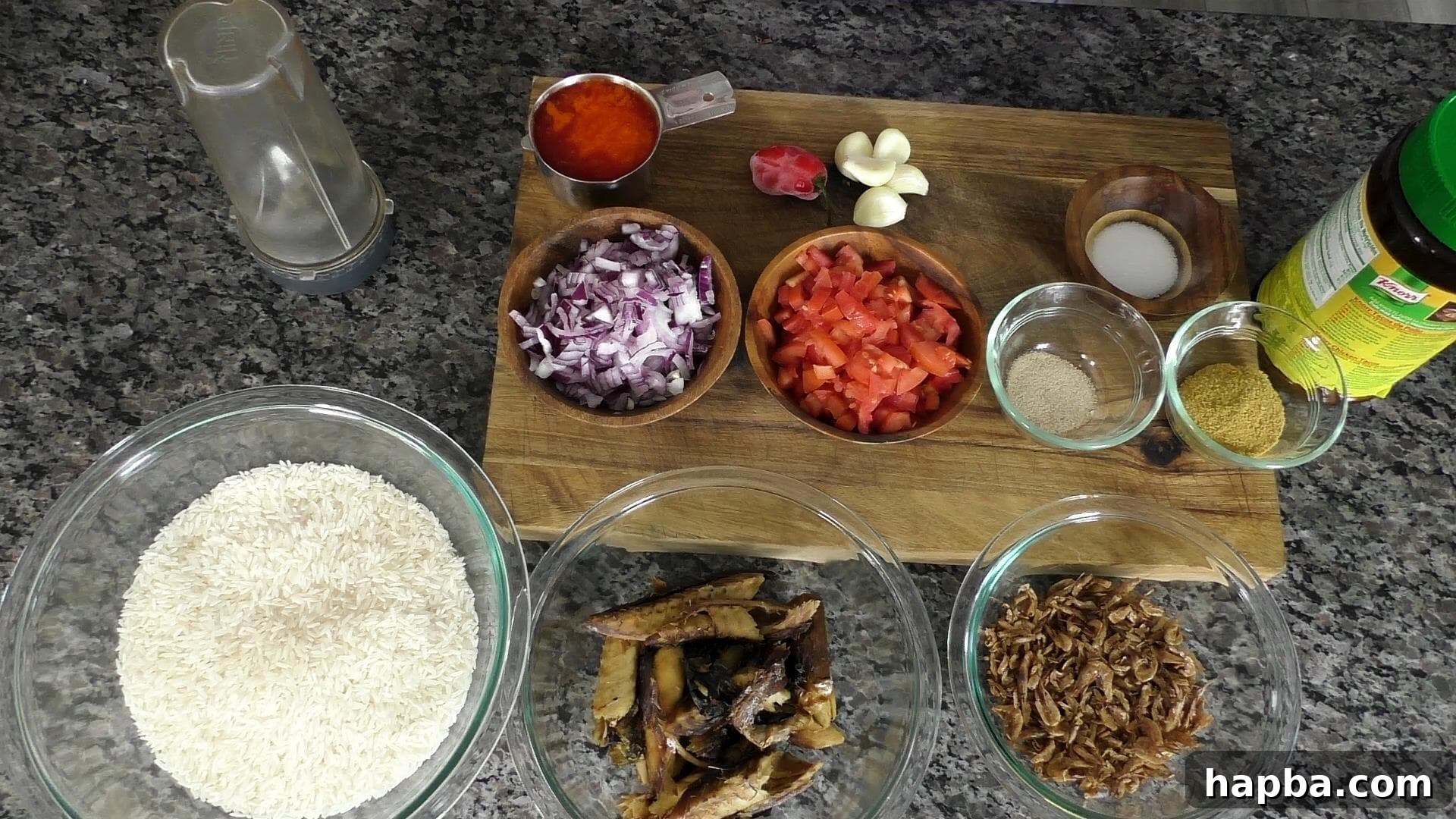 Assortment of fresh ingredients for Njanga Rice including palm oil, crayfish, tomatoes, onions, and rice.