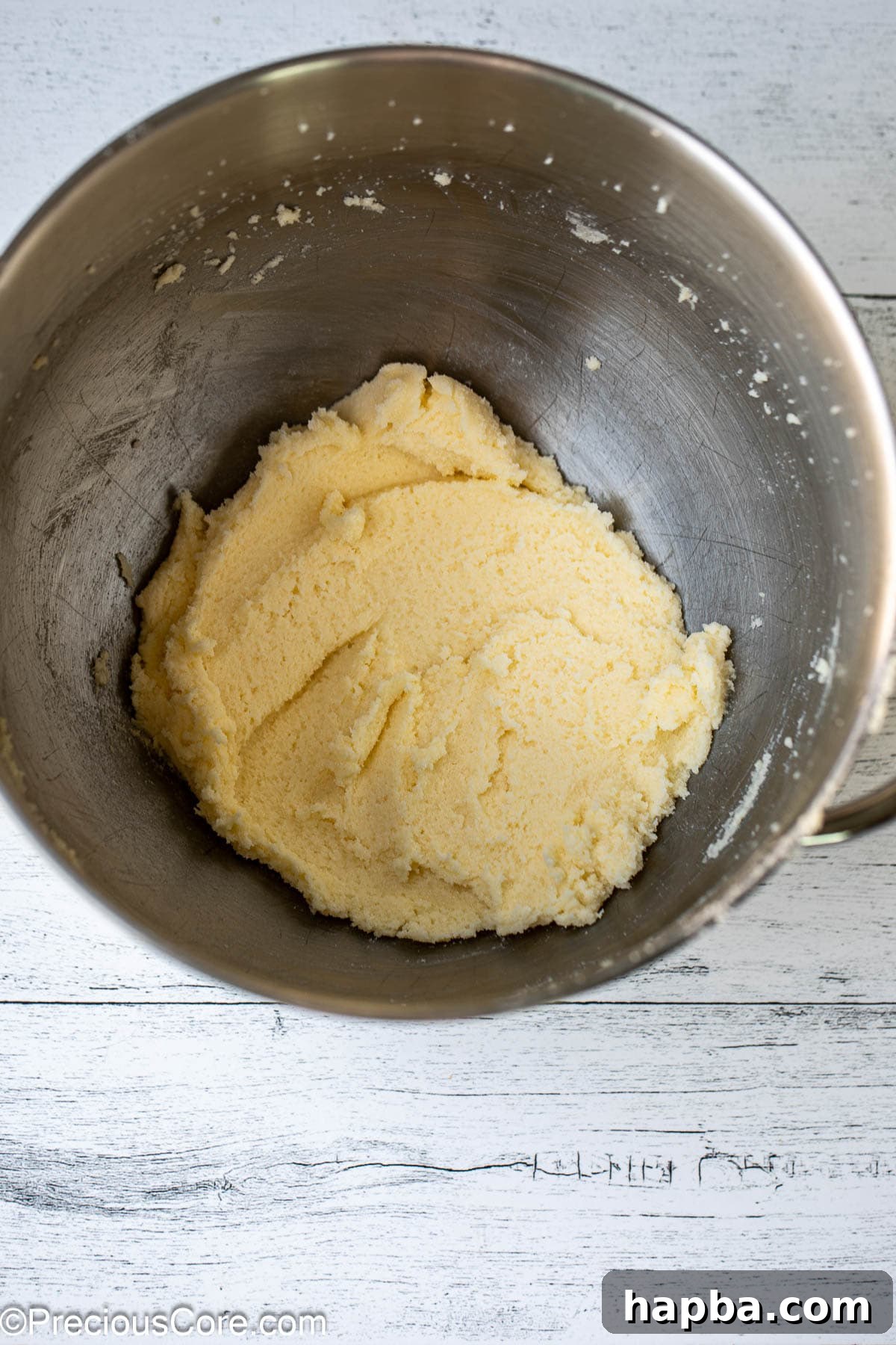Close-up of butter and sugar expertly creamed together in a mixing bowl, creating a light and fluffy texture.