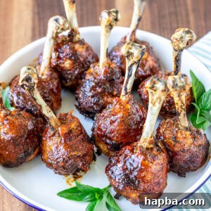 Plate of baked and glazed chicken lollipops.
