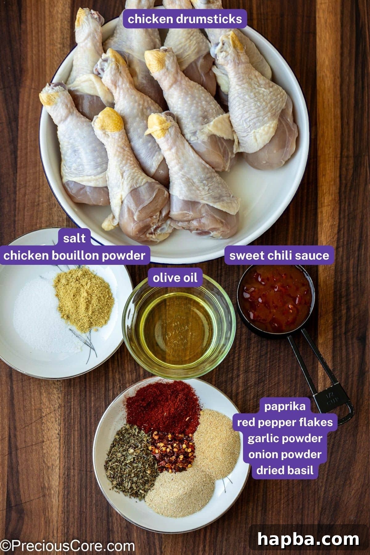A flat lay of all ingredients needed to prepare chicken drumstick lollipops, including spices, oil, and sauce.