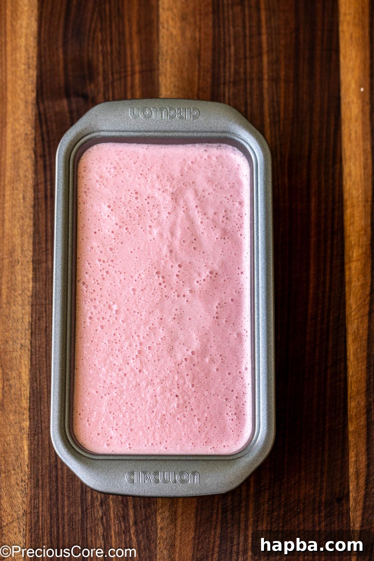Watermelon ice cream mixture in a loaf pan.