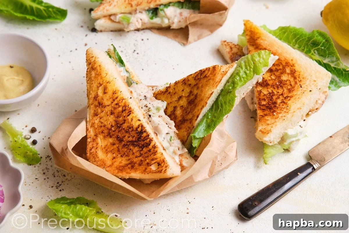 Classic Creamy Chicken Sandwich 6 Beautifully served chicken sandwiches, neatly wrapped in parchment paper and ready to be enjoyed.