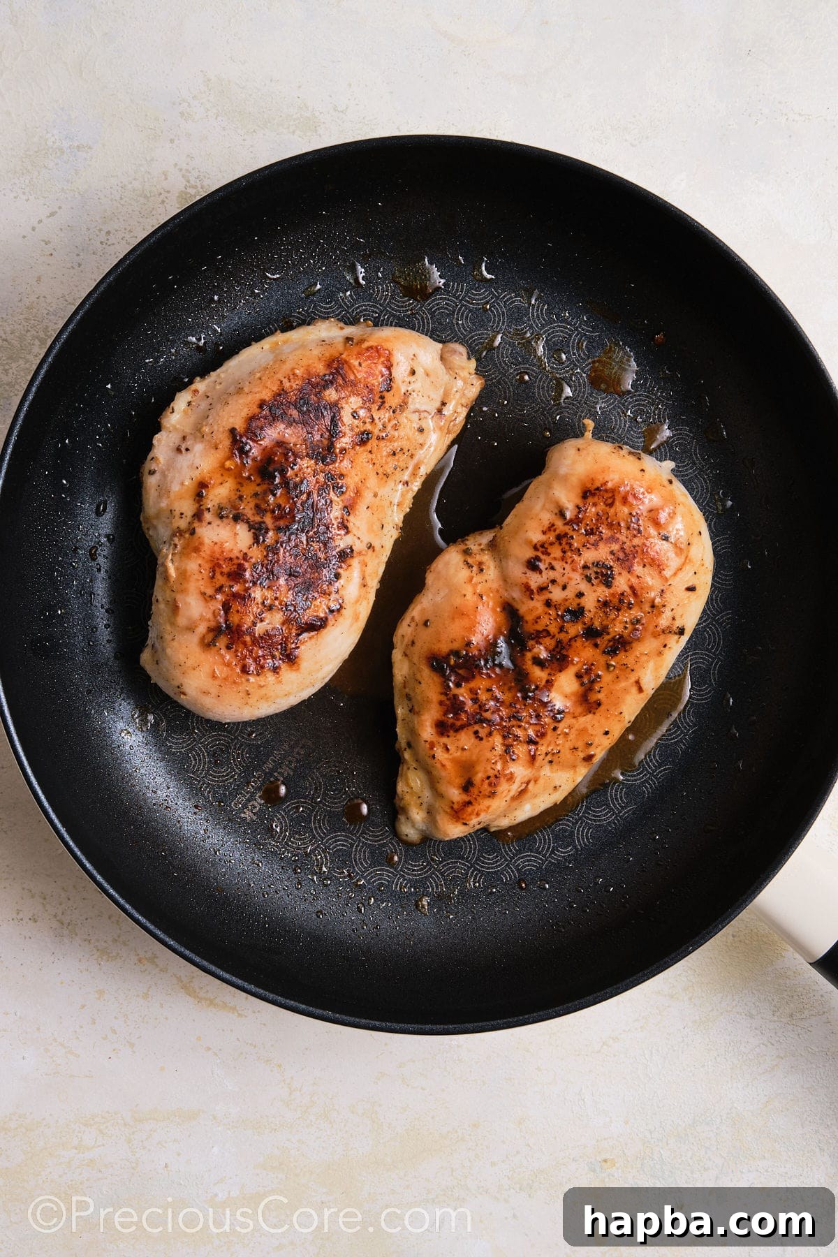 Classic Creamy Chicken Sandwich 8 Searing seasoned chicken breasts in a hot skillet, achieving a golden-brown crust.
