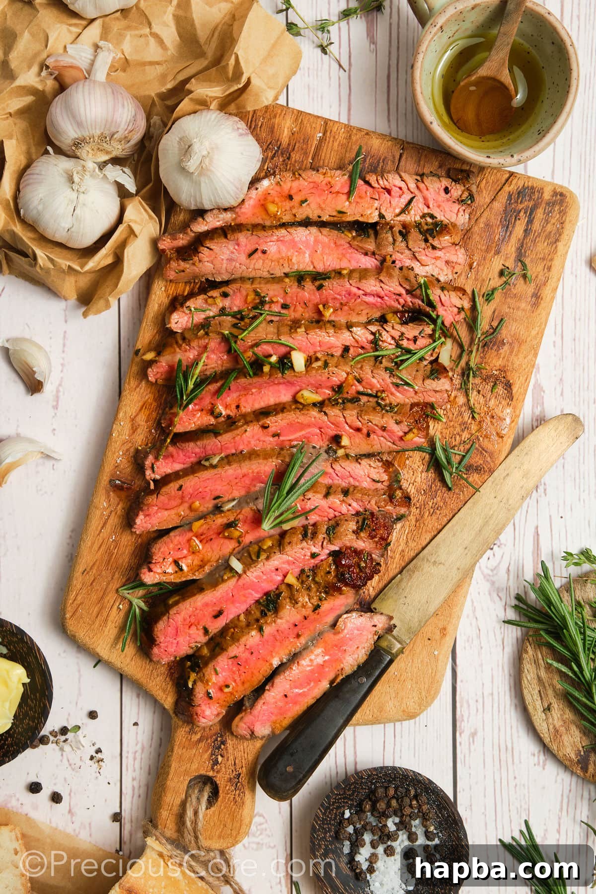 Perfectly sliced flank steak, revealing a vibrant pink interior, served on a cutting board, ready to be enjoyed.