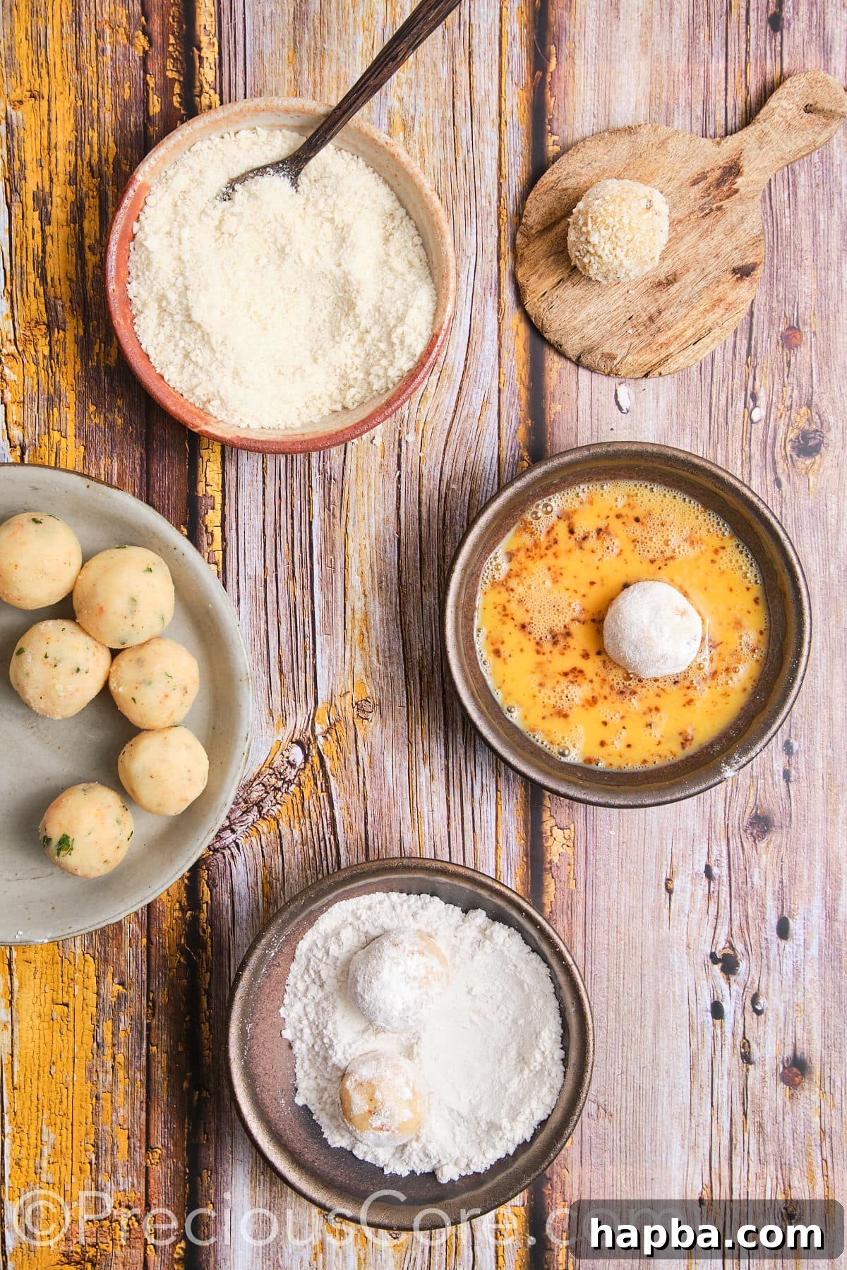 Egg mixture, flour on a plate, and breadcrumbs for potato cheese balls coating.