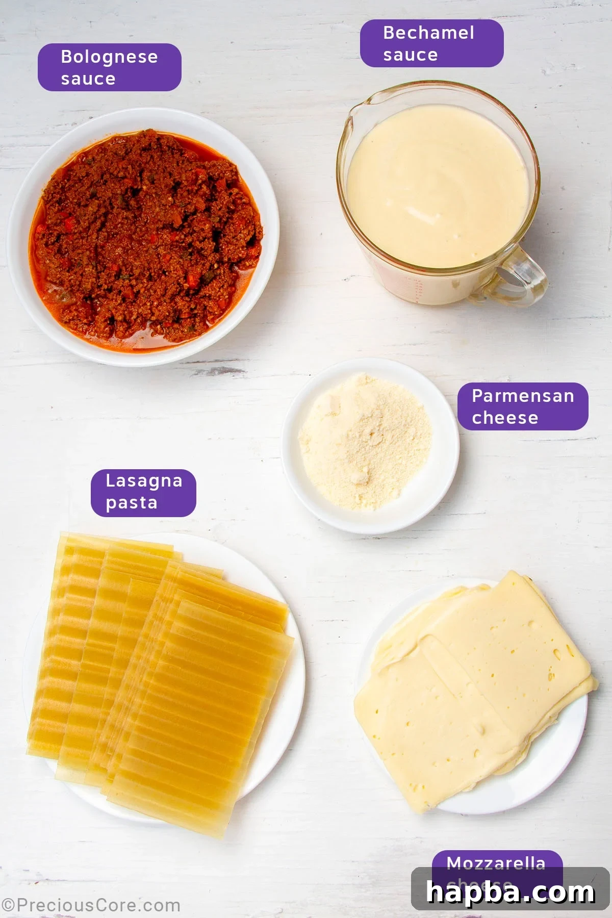 Creamy Béchamel Lasagna 6 Ingredients laid out for assembling lasagna: prepared béchamel sauce, prepared Bolognese sauce, lasagna pasta sheets, shredded mozzarella, and Parmesan cheese.
