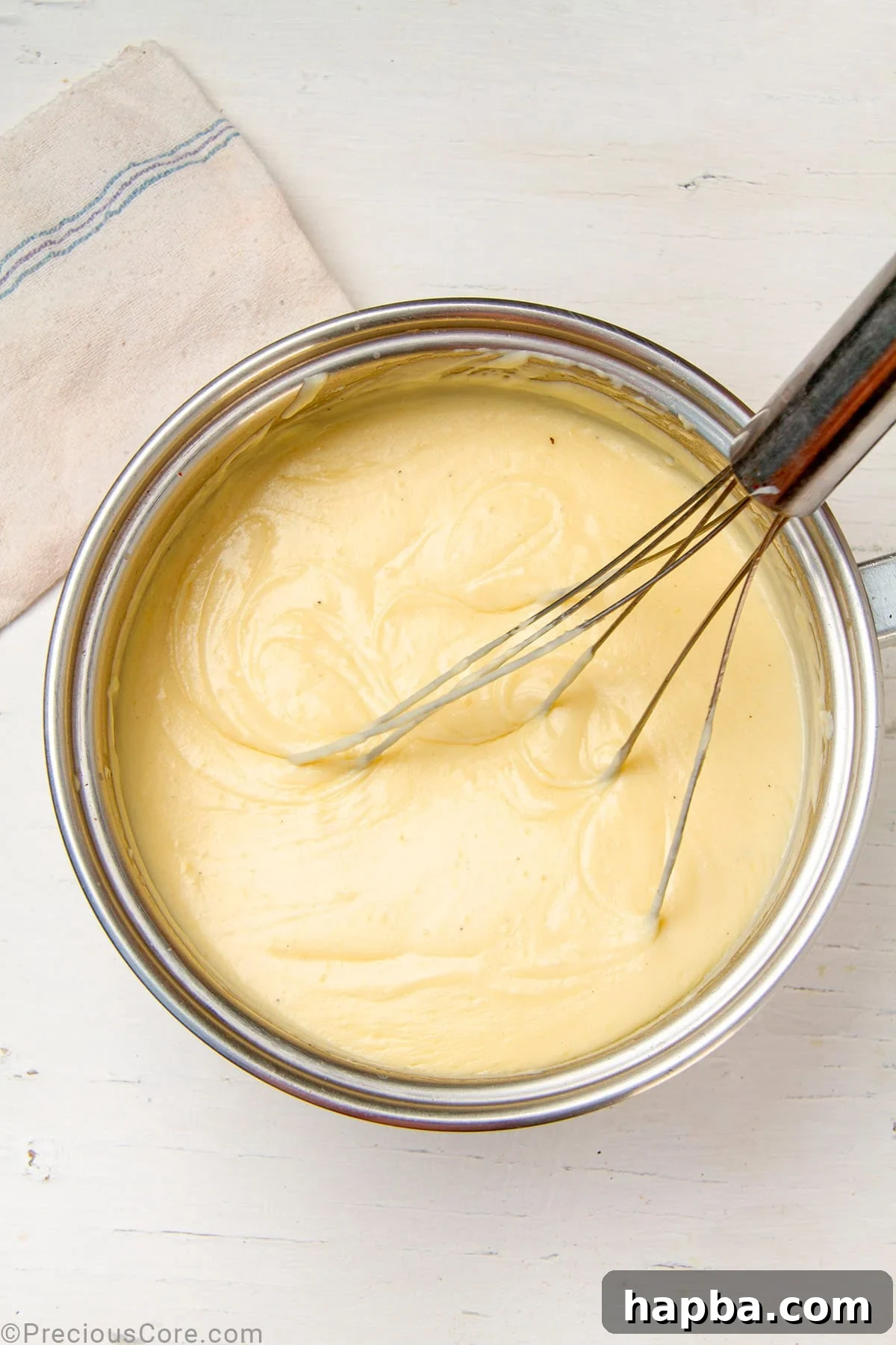 Creamy Béchamel Lasagna 10 Smooth, creamy homemade béchamel sauce resting in a pot, demonstrating its perfect consistency.