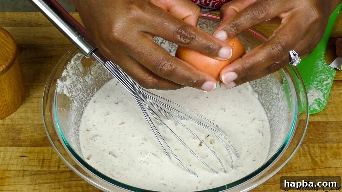 Wrapping egusi pudding mixture in banana leaves