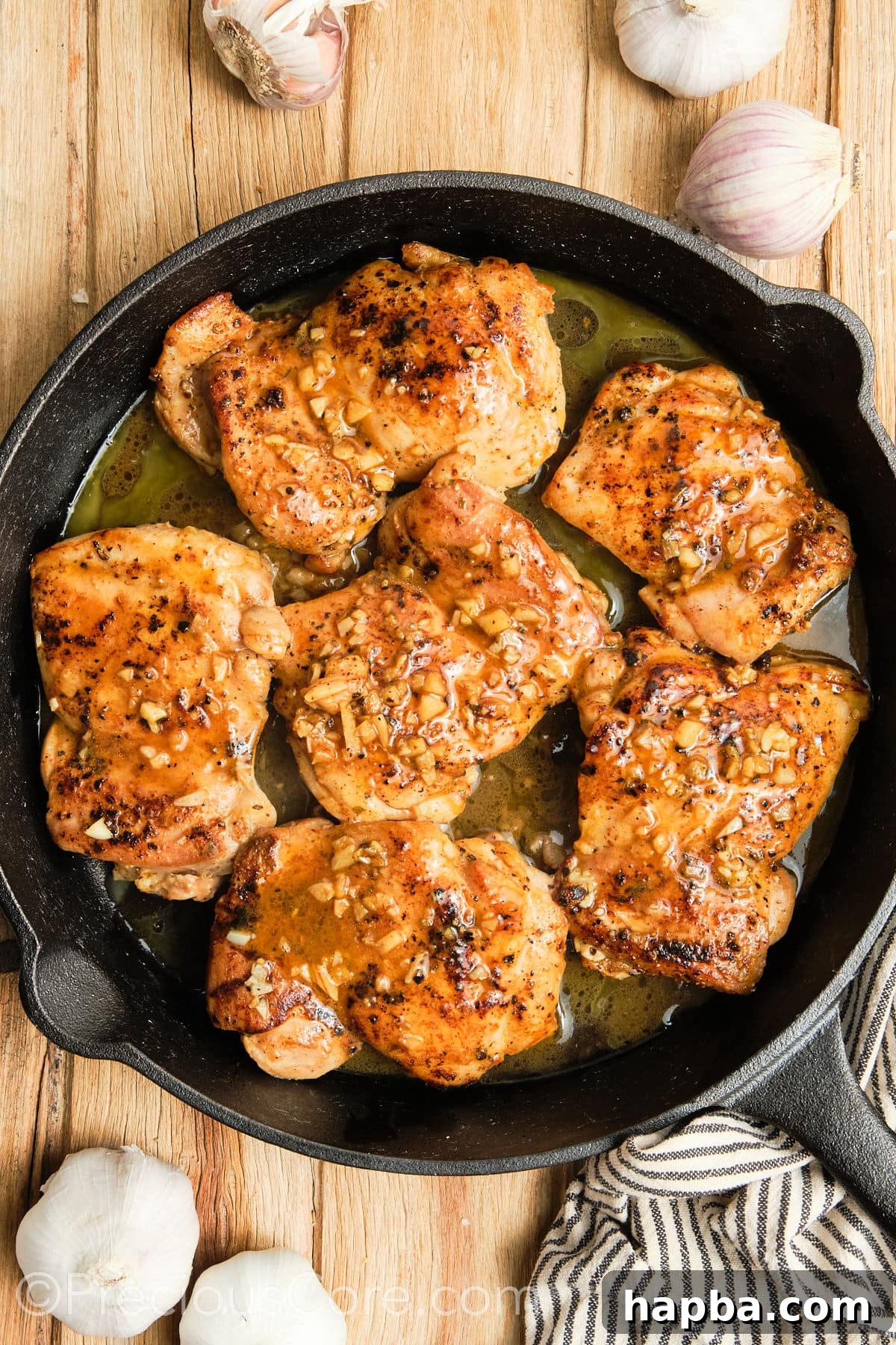 Cooked chicken thighs in a cast iron skillet.