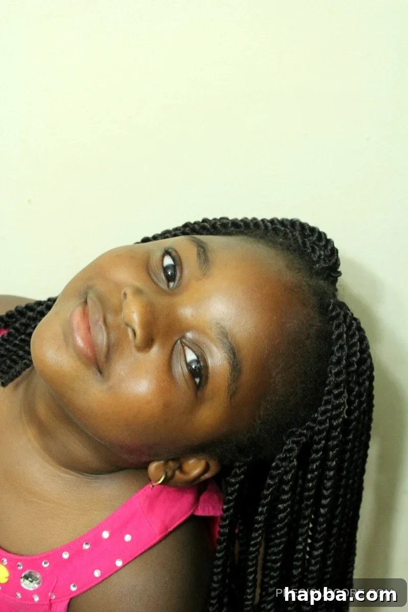 Smiling child with beautiful, neat crochet braids, a testament to easy protective styling