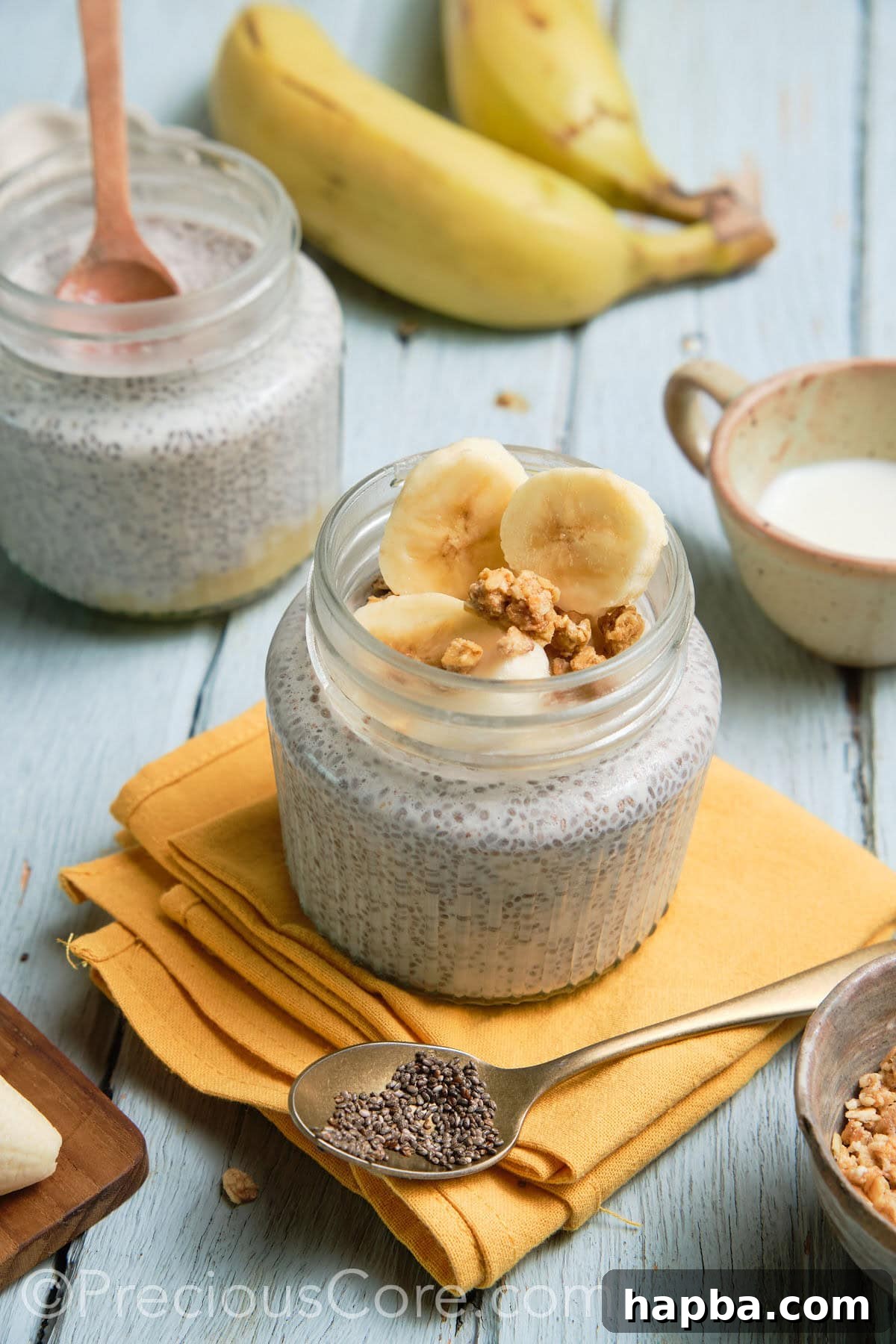 Two aesthetically arranged jars of banana chia pudding, ready for enjoyment.