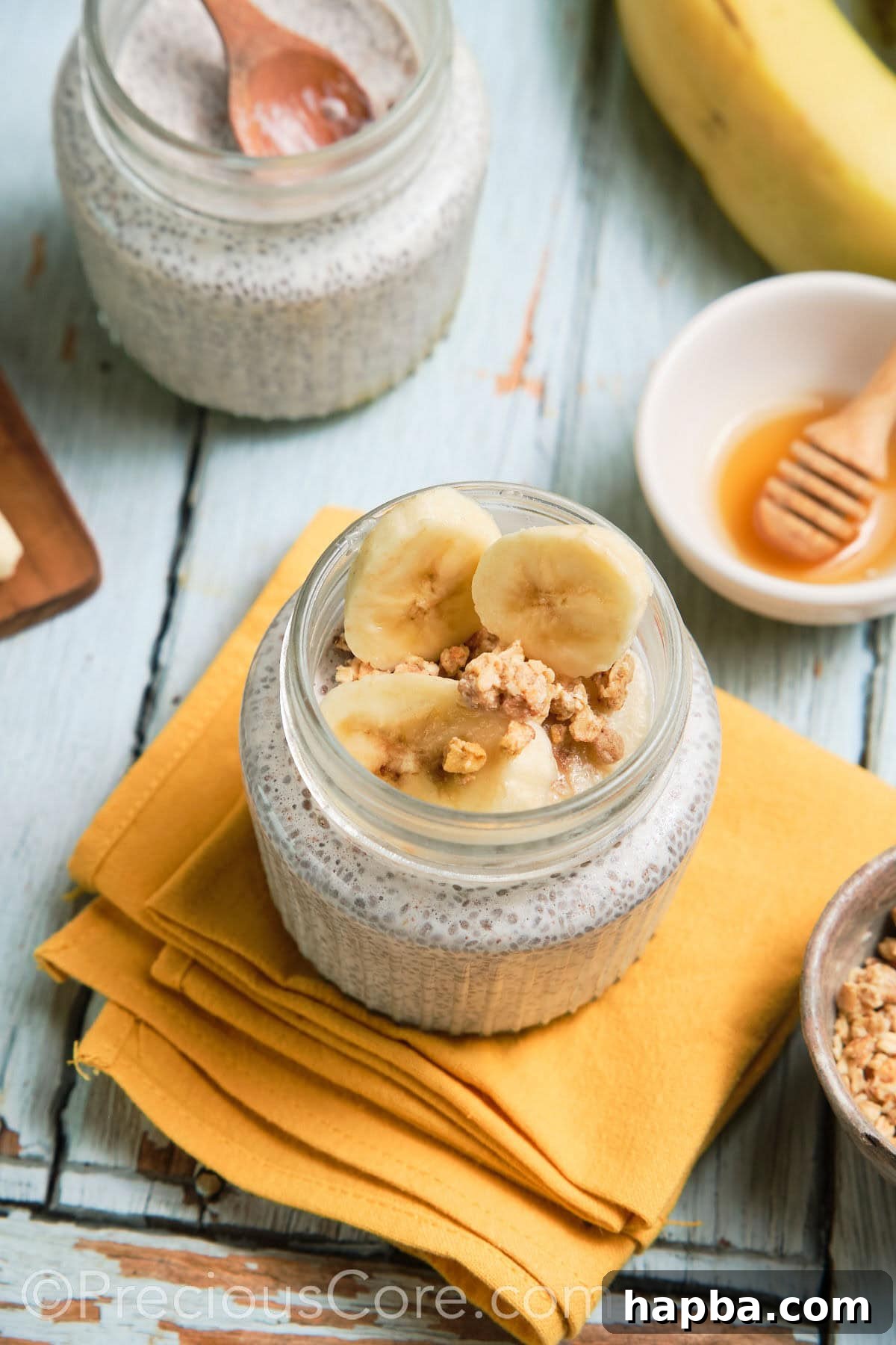Two glass jars of perfectly prepared chia pudding, ready for customization.