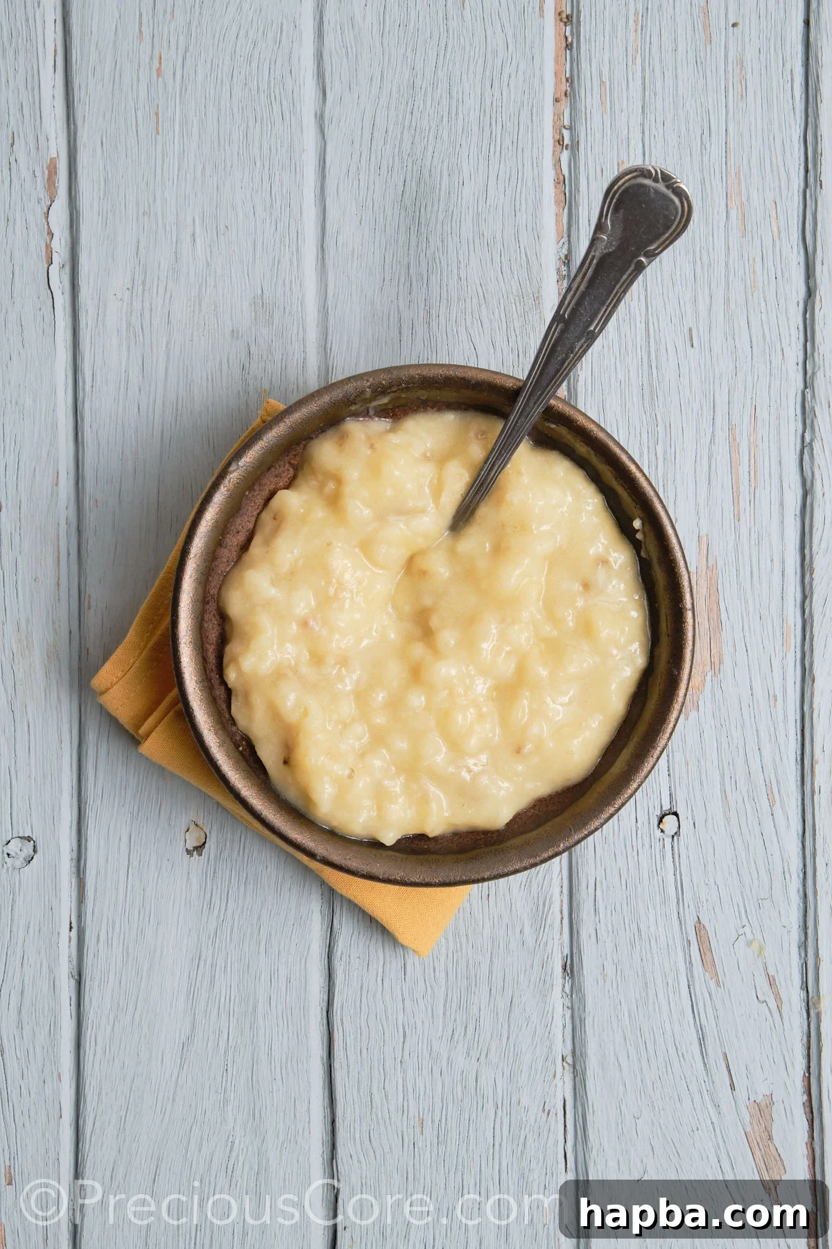 Close-up of mashed bananas in a bowl, demonstrating the desired smooth consistency.