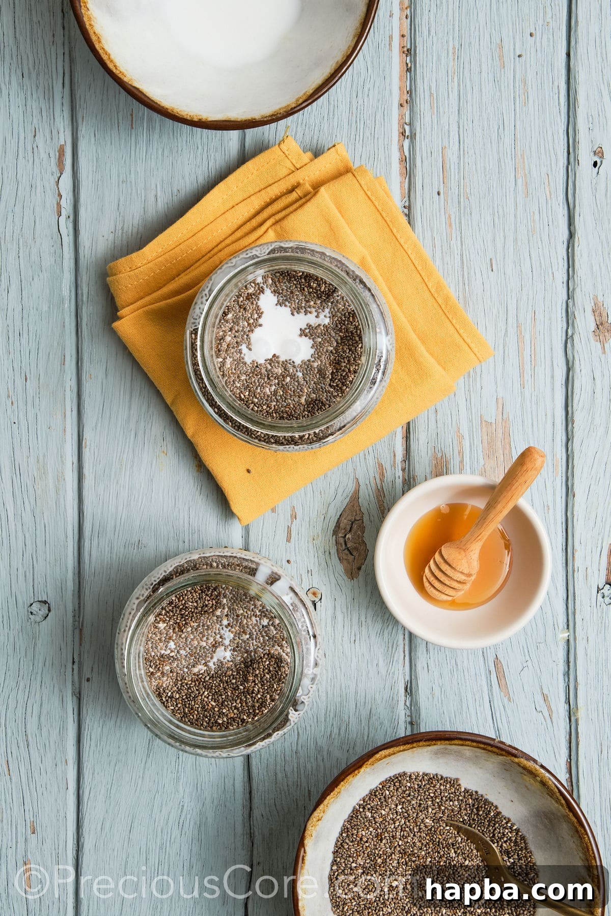 Coconut milk and other ingredients being added to a glass jar with mashed bananas.