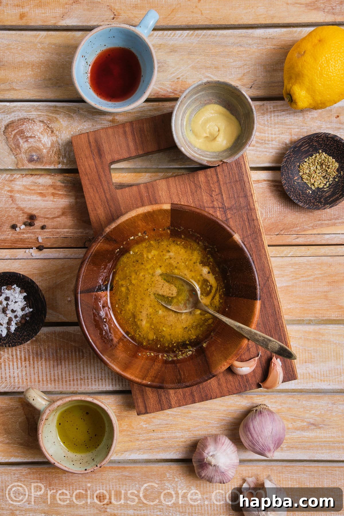 A small bowl containing a perfectly emulsified, golden salad dressing.