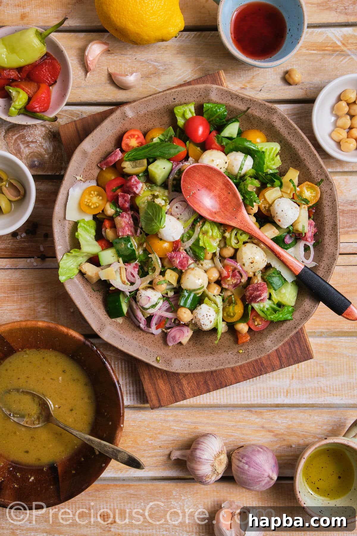A vibrant Italian chopped salad, freshly tossed with dressing, ready to be served.