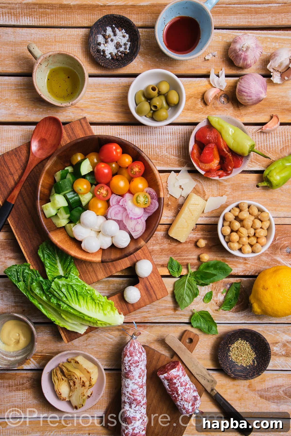 A selection of fresh, colorful ingredients laid out, ready for an Italian Chopped Salad.
