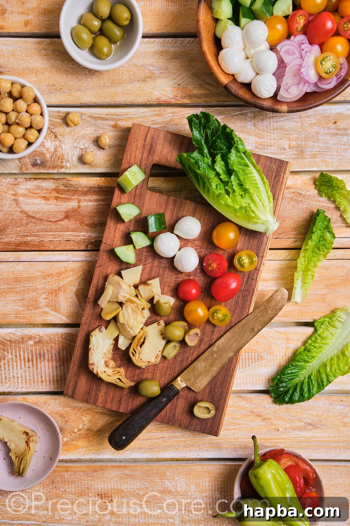 Close-up of fresh vegetables being chopped on a wooden cutting board.