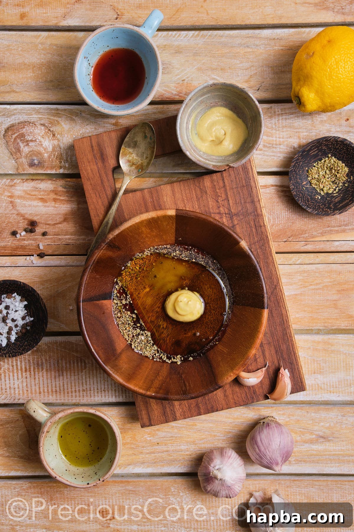 Individual ingredients for salad dressing, including olive oil, vinegar, and herbs, arranged in small containers.