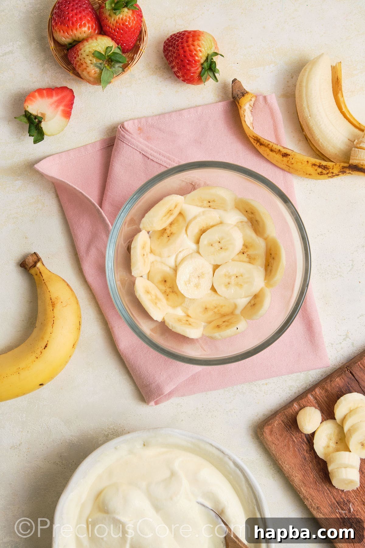 Adding a layer of bananas to pudding.
