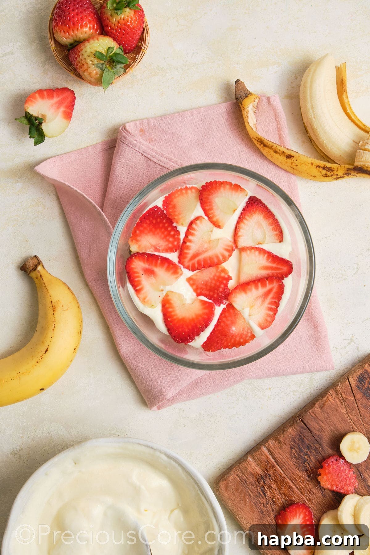 Sliced strawberries added to pudding.