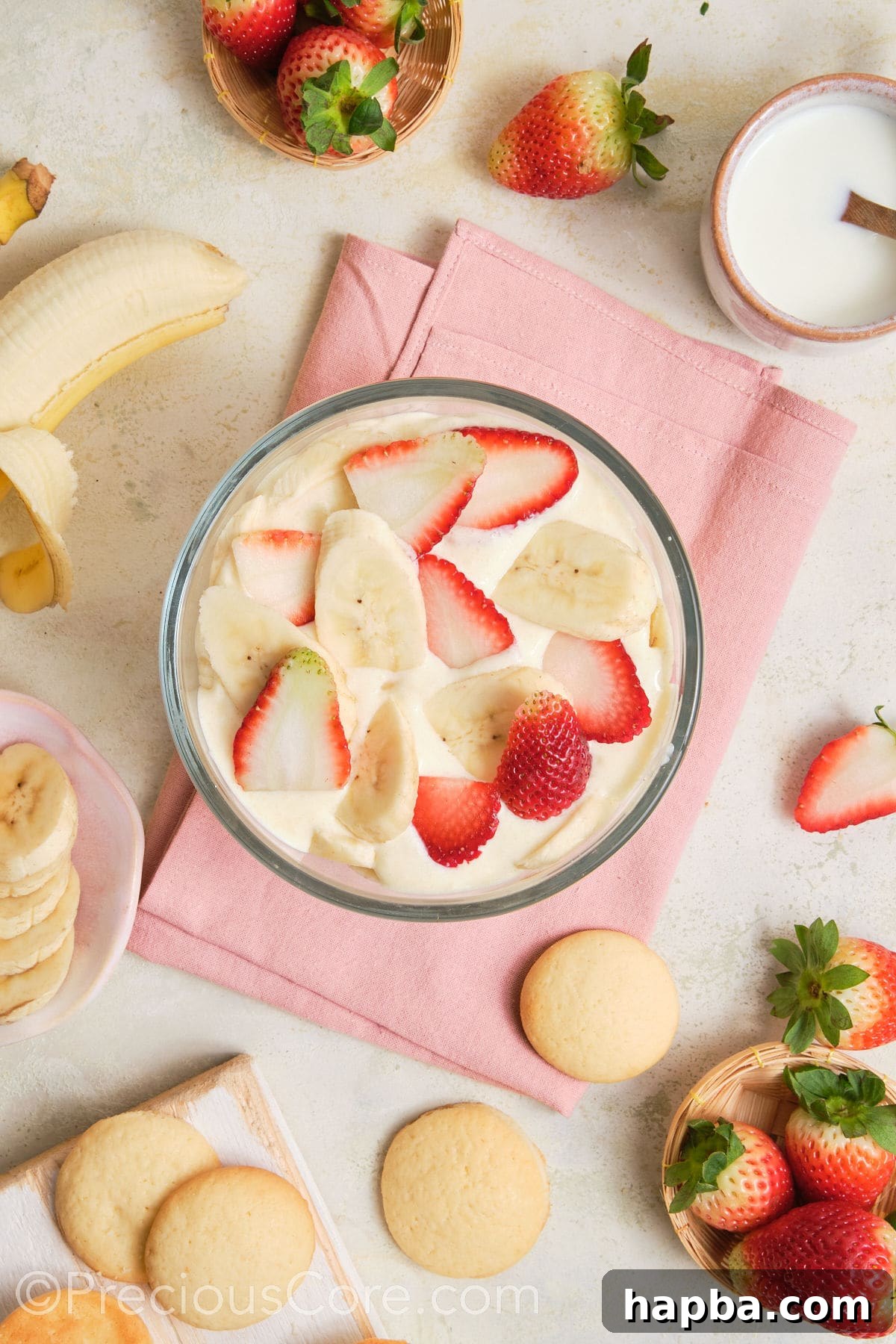 A layer of strawberries and bananas over pudding.