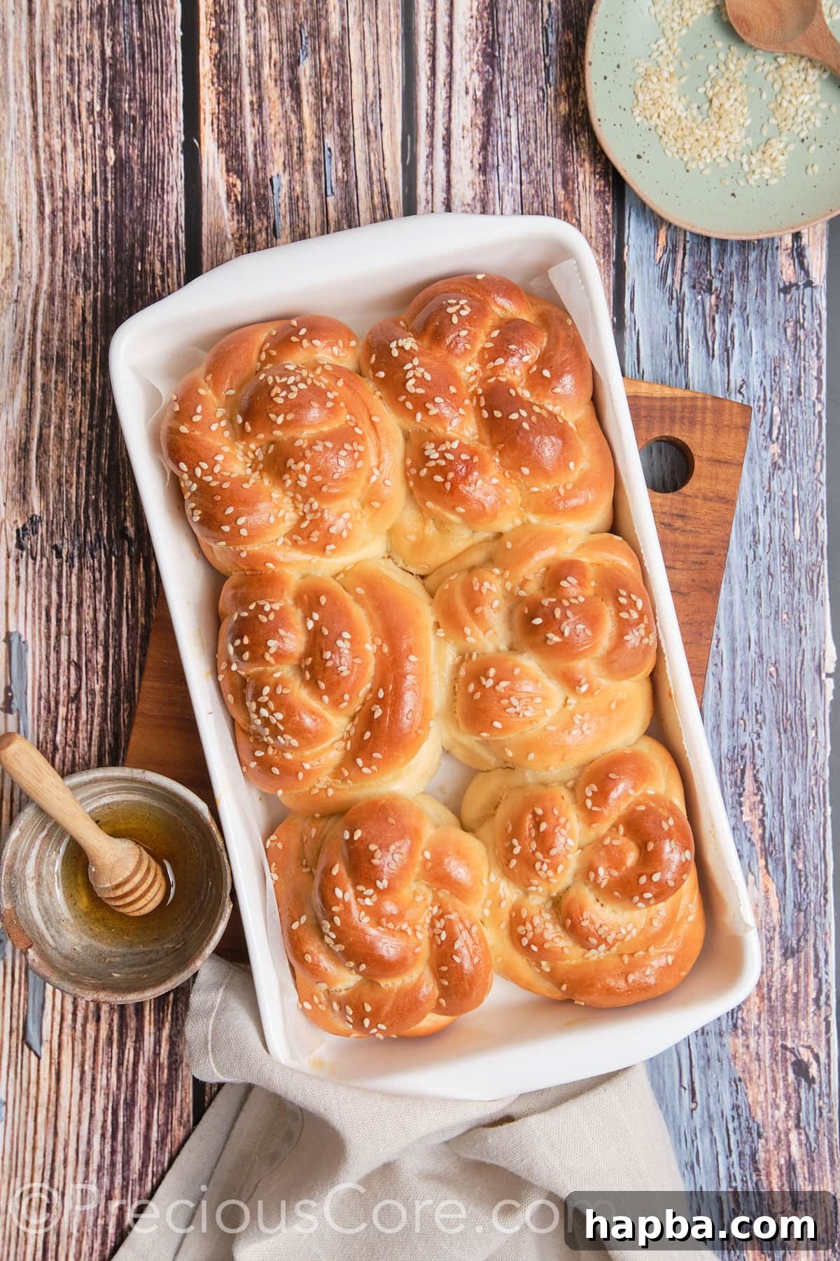 Golden Challah Dinner Buns 13 Freshly baked golden brown challah rolls, still hot from the oven.