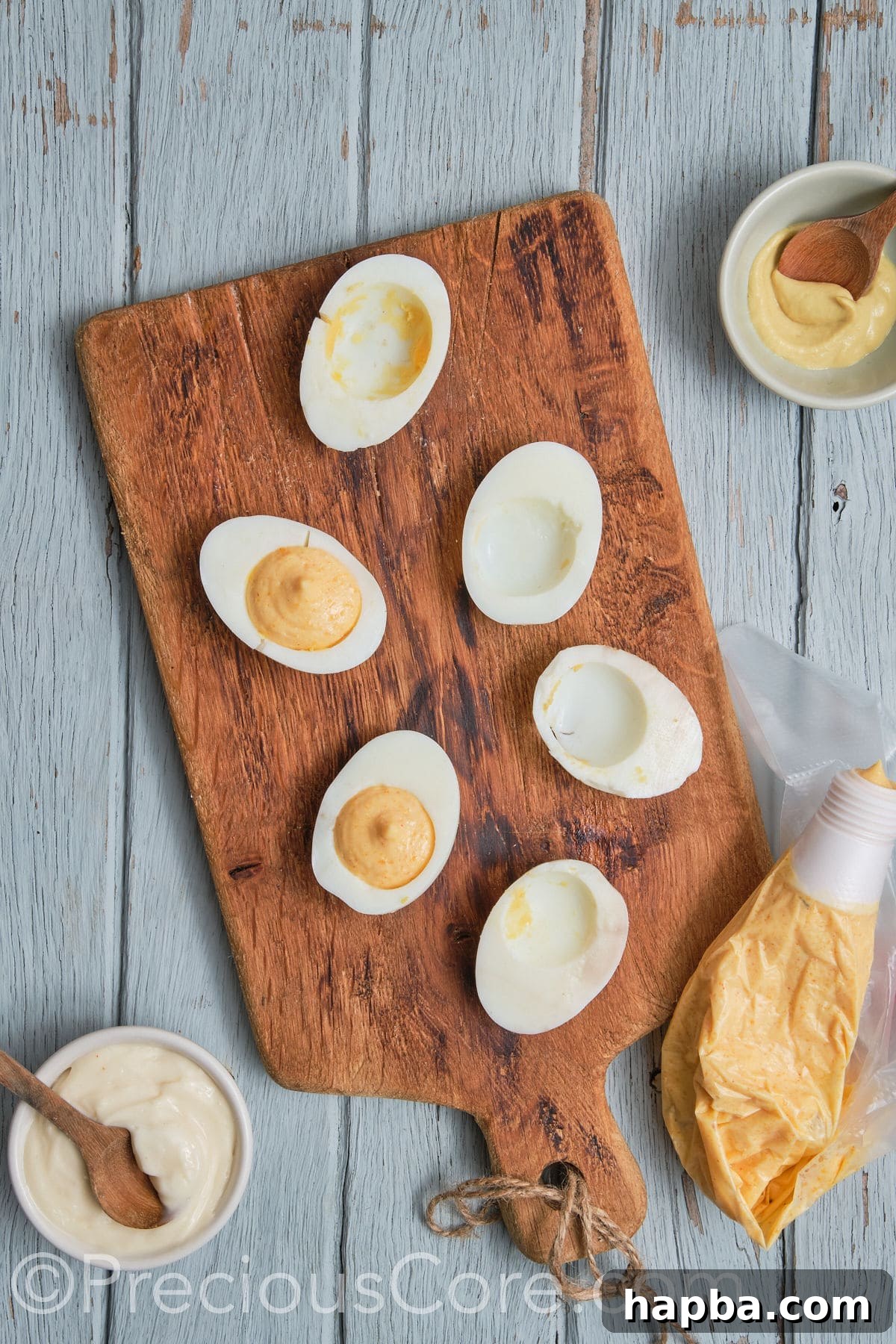 Kickin' Cajun Shrimp Deviled Eggs 19 egg halves with egg yolk mixture scooped.