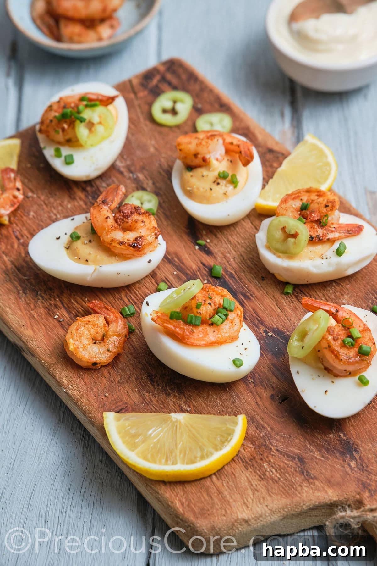 Kickin' Cajun Shrimp Deviled Eggs 3 Side shot of delicious-looking deviled eggs topped with shrimp.