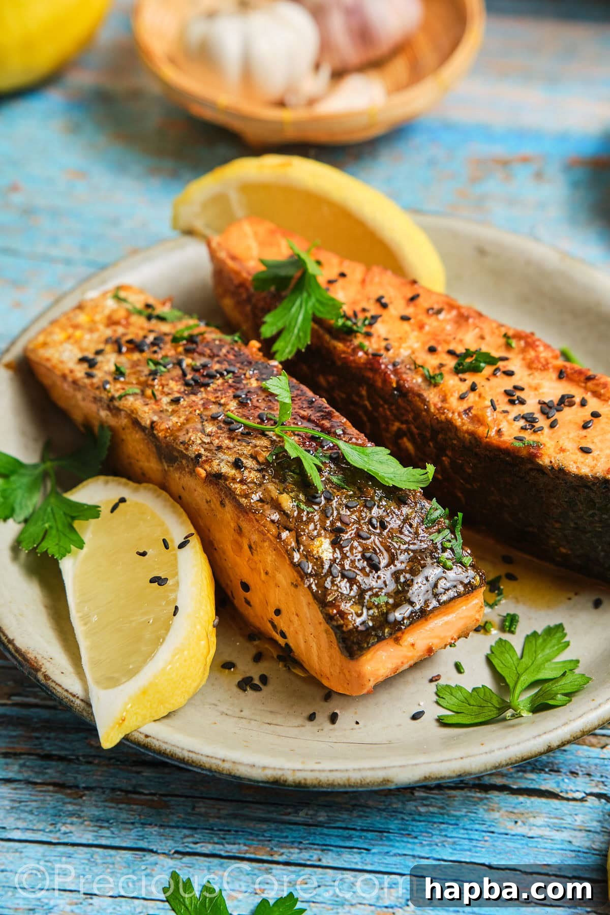 Perfectly cooked Cajun Honey Butter Salmon fillet garnished with fresh herbs on a white plate, ready to be served.