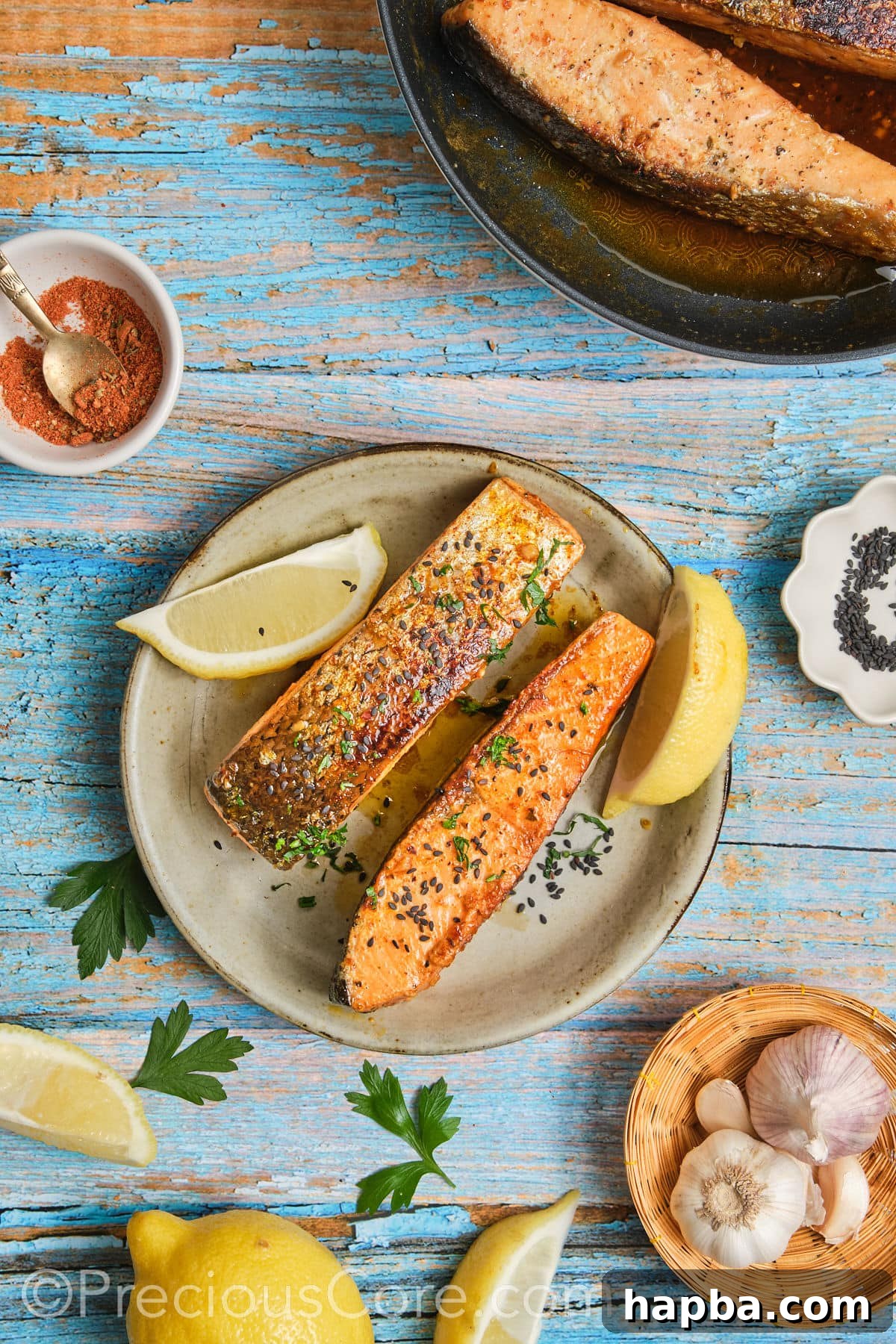 Finished Cajun Honey Butter Salmon garnished with freshly chopped parsley and lemon wedges on a serving platter.