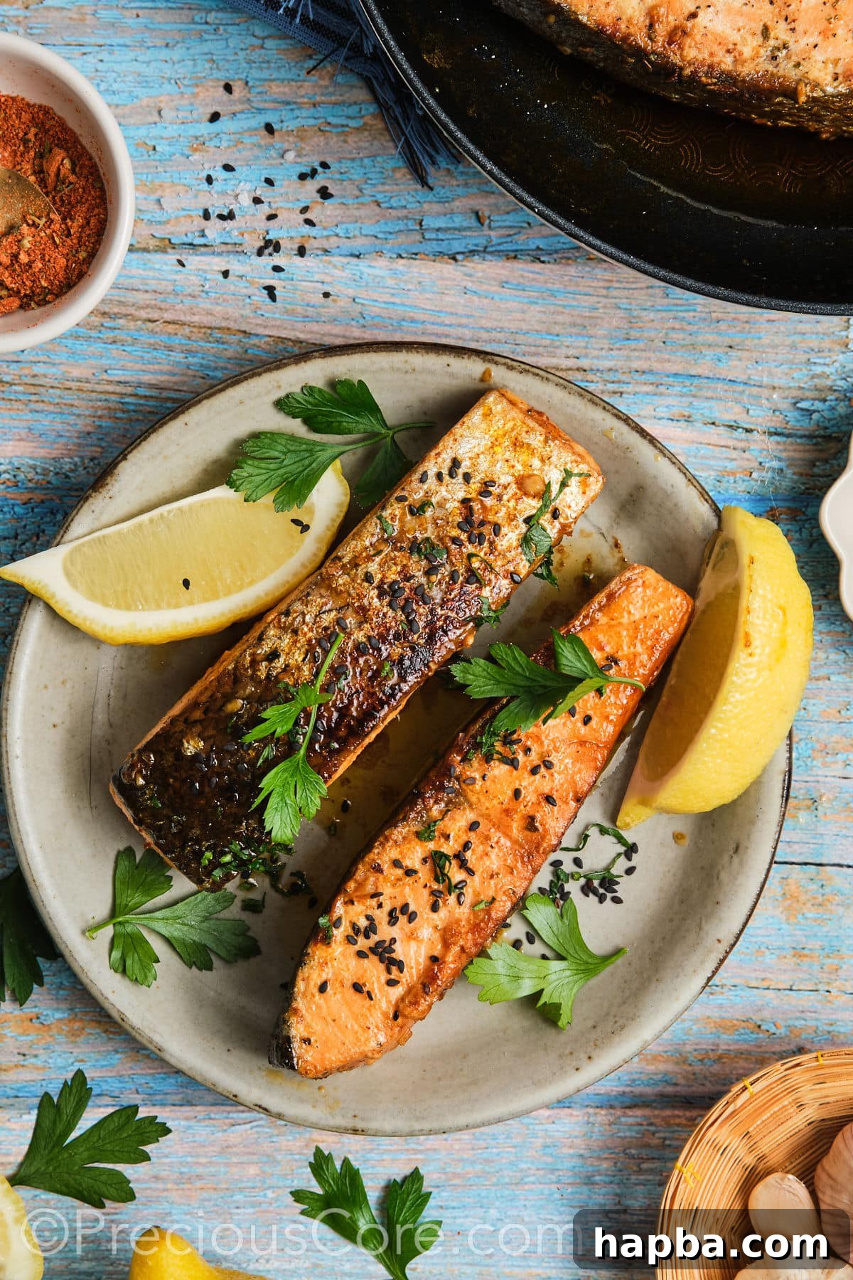 Beautifully cooked Cajun Honey Butter Salmon fillet, garnished with fresh parsley and black sesame seeds on a plate.