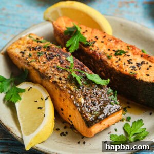 Cajun Honey Butter Salmon on a plate, perfectly cooked and garnished.