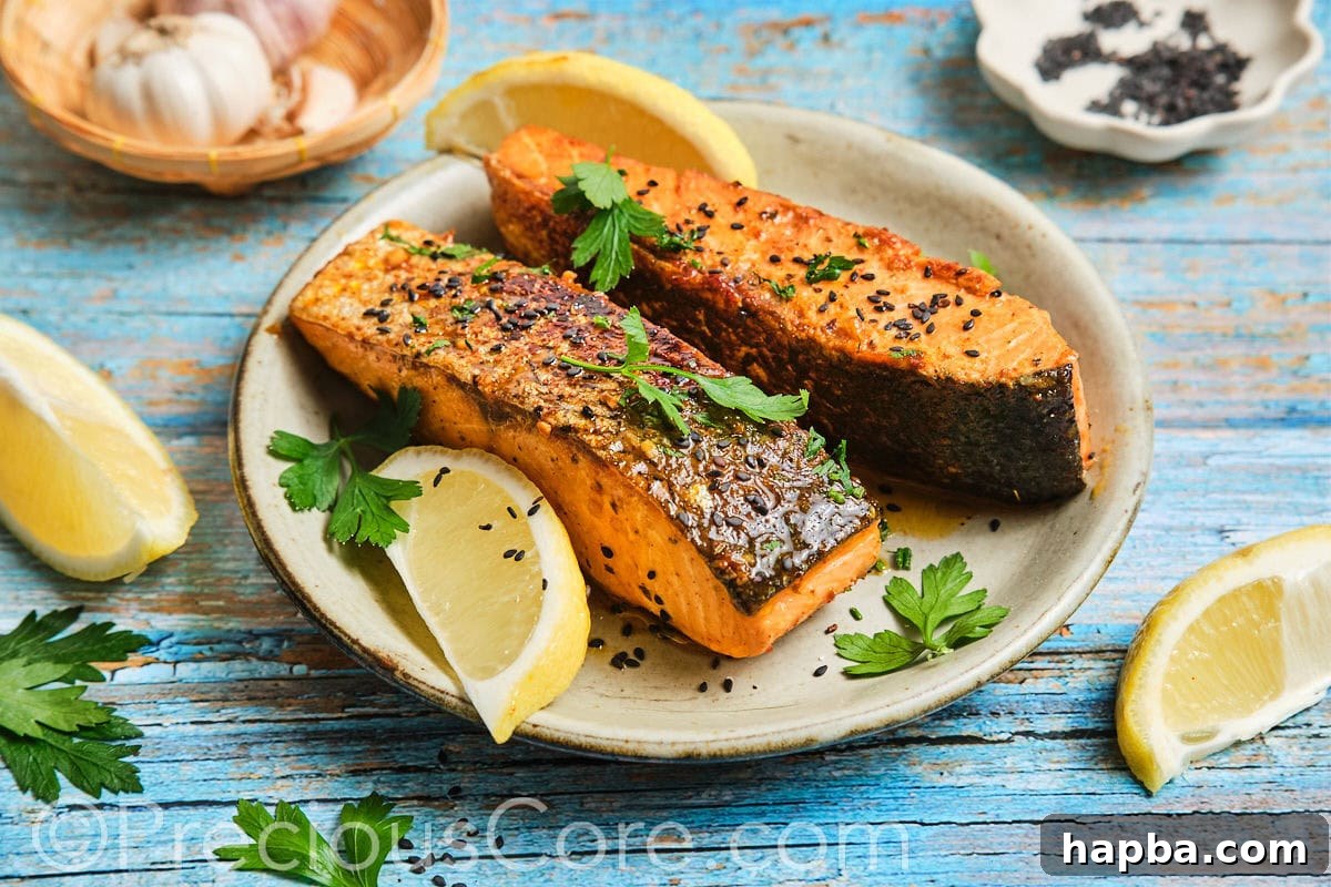 A stunning landscape image of a single, perfectly cooked Cajun Honey Butter Salmon fillet on a plate with garnishes.