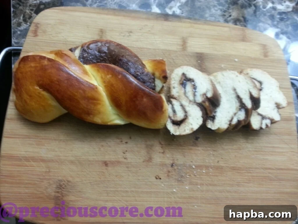 Foolproof Chocolate Bread Perfection 5 A slice of Nutella braided bread, revealing the delicate layers of dough and chocolate spread.