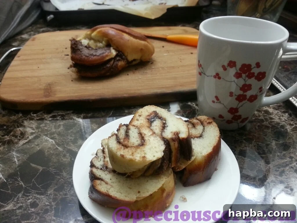 Foolproof Chocolate Bread Perfection 6 A freshly baked slice of Nutella bread next to a cup of coffee, suggesting a perfect pairing.
