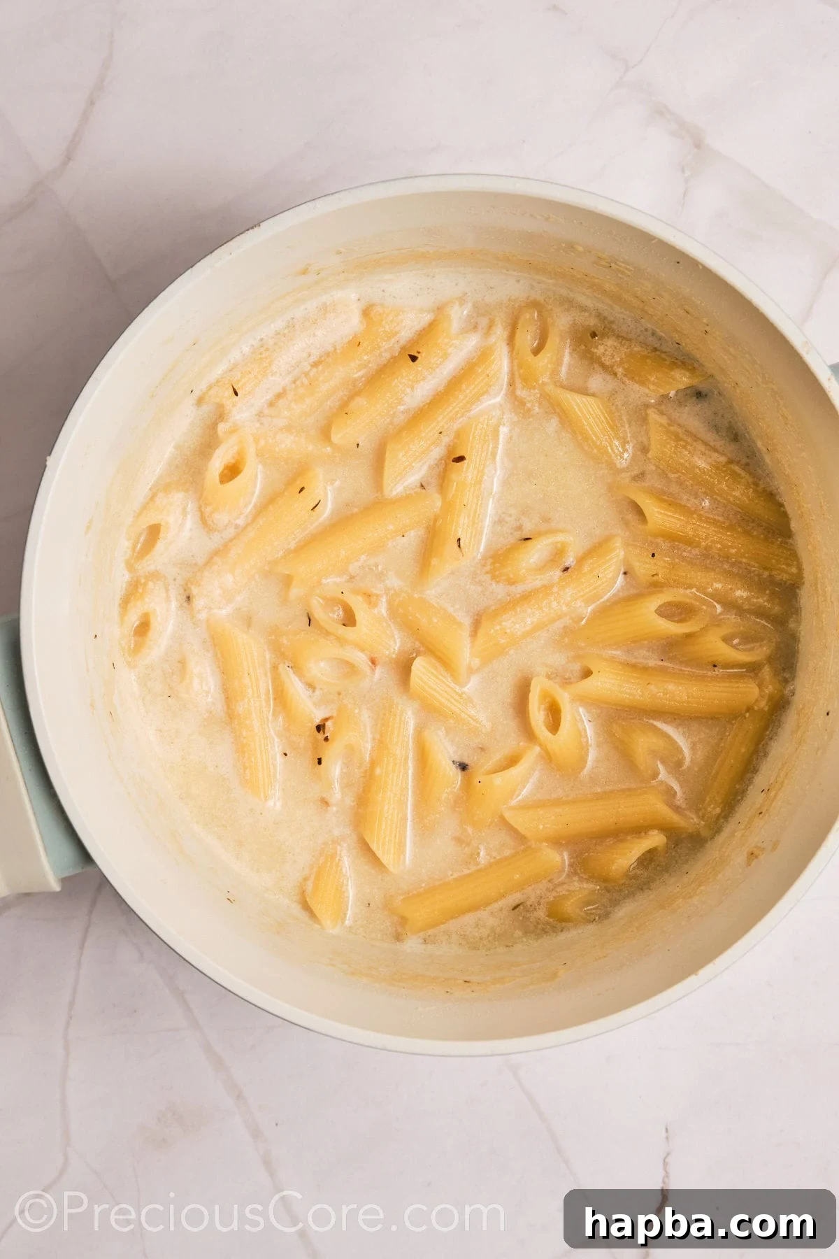 Velvety One-Pan Chicken Pasta 12 Pasta added to creamy liquid.