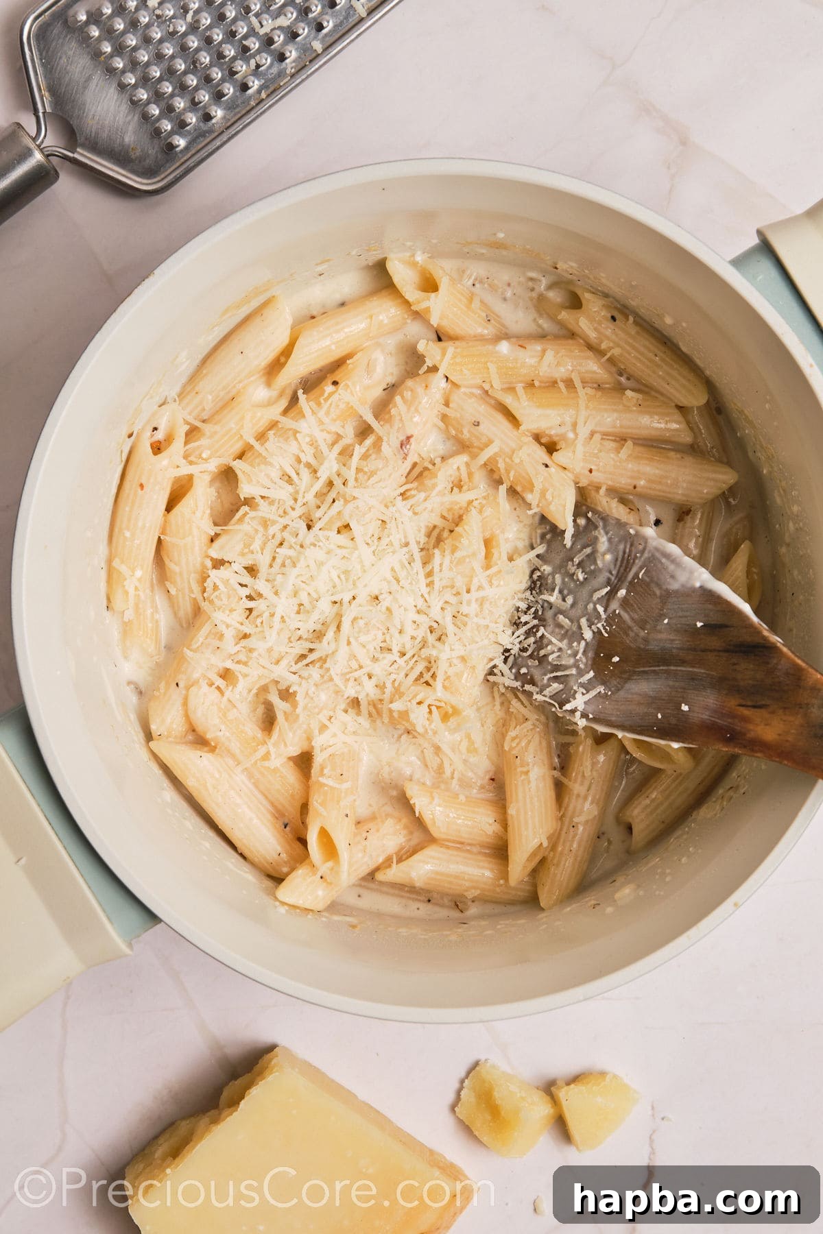Velvety One-Pan Chicken Pasta 16 Parmesan added to the pot of creamy pasta.