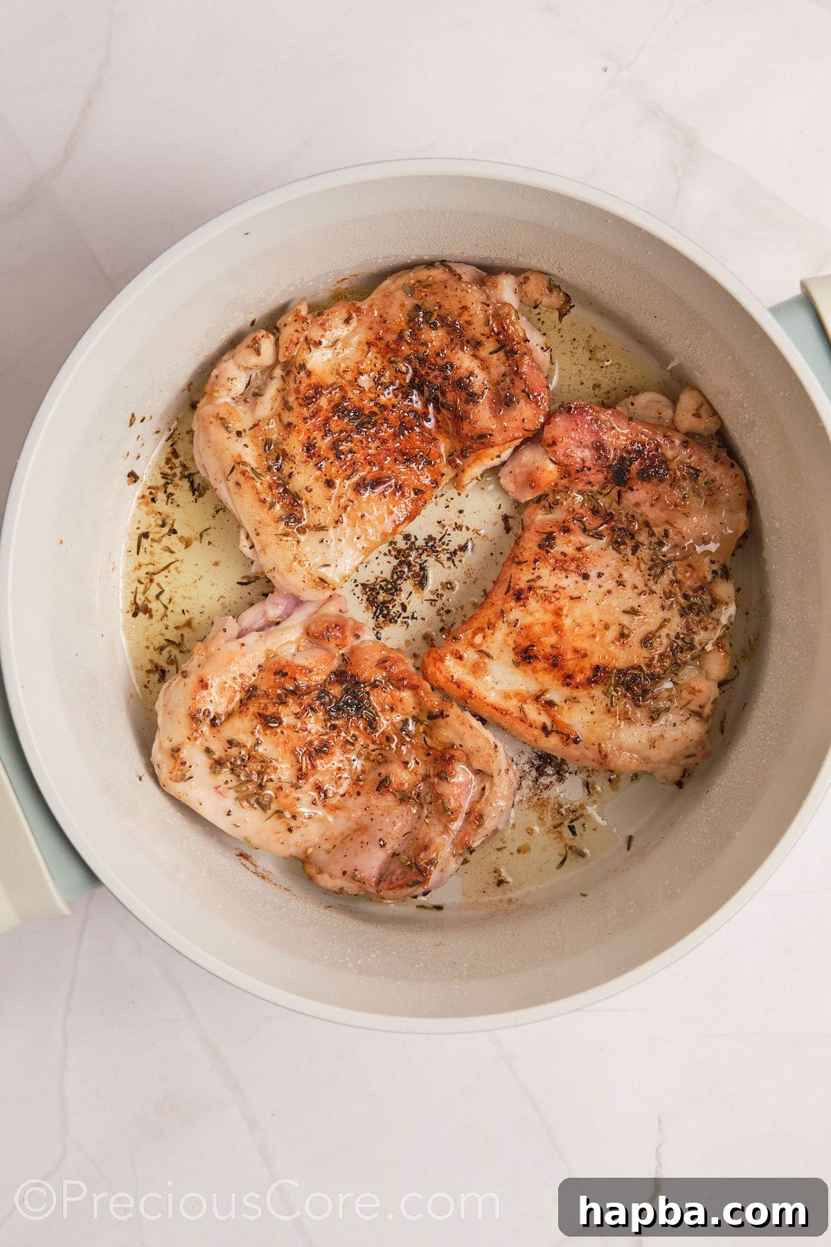 Velvety One-Pan Chicken Pasta 9 Browned chicken thighs in a pot.