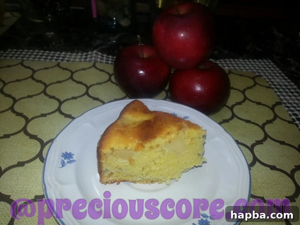 A delicious slice of homemade apple cake, heart-shaped, made by children.