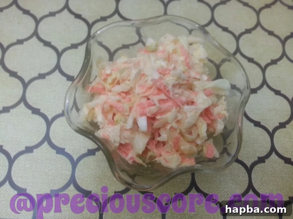 A bowl of fresh, homemade coleslaw, enjoyed by a child.