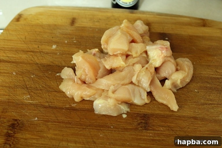Chicken strips seasoned with soy sauce in a bowl, marinating