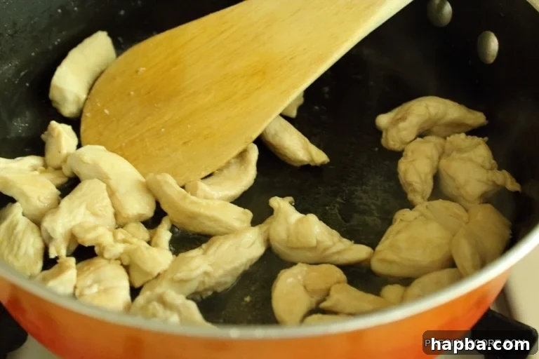Fried chicken pieces, cooked to golden perfection, ready to be removed from the pot
