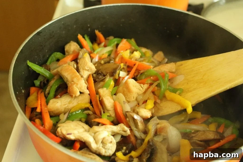 Close-up of the finished chicken and mushroom stir fry, vibrant with fresh vegetables