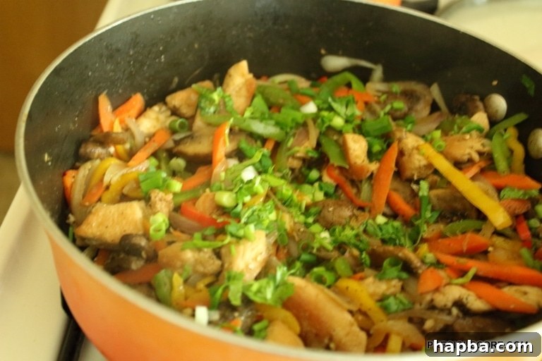 Chicken and mushroom stir fry garnished with fresh green onions